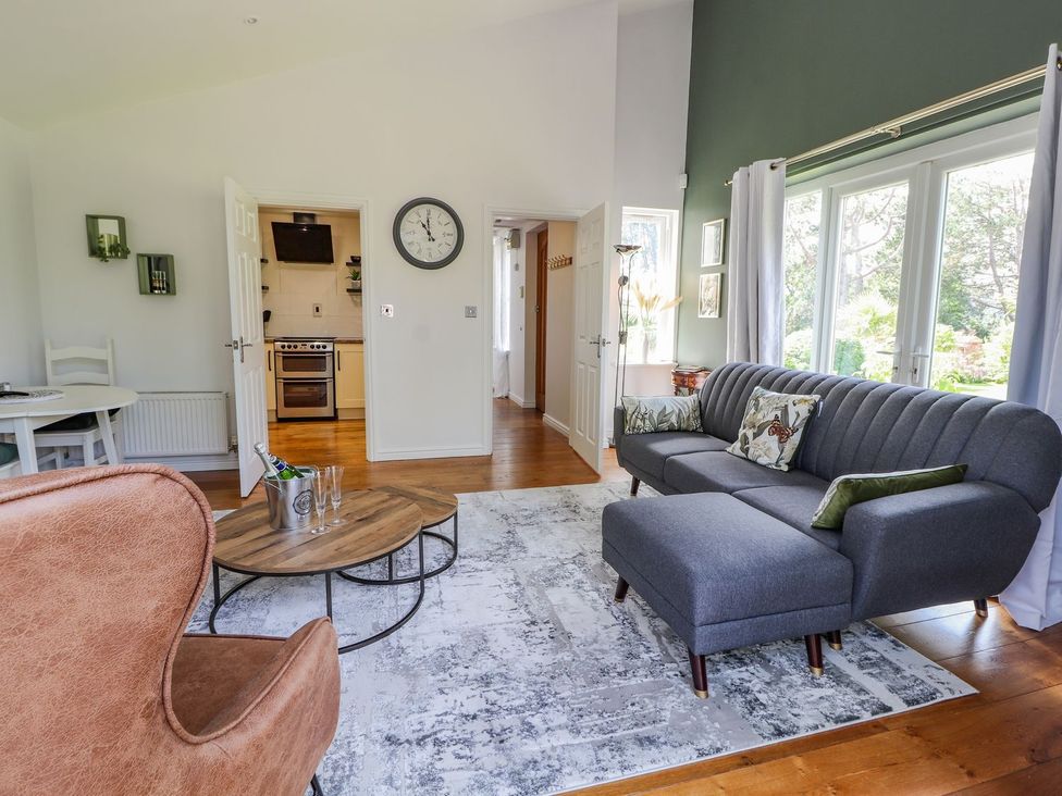 A living room with a sofa and coffee table at Mount House Bryniau near Dyserth