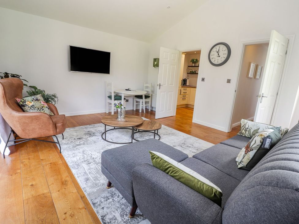 A living room with a sofa and coffee table at Mount House Bryniau near Dyserth