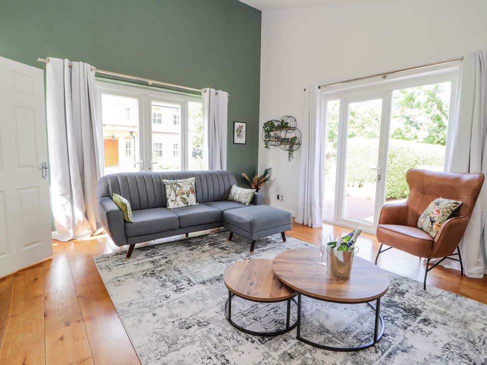 A living room with a sofa and coffee table at Mount House Bryniau near Dyserth