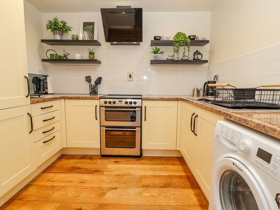 A kitchen with cabinets and appliances at Mount House in Bryniau near Dyserth