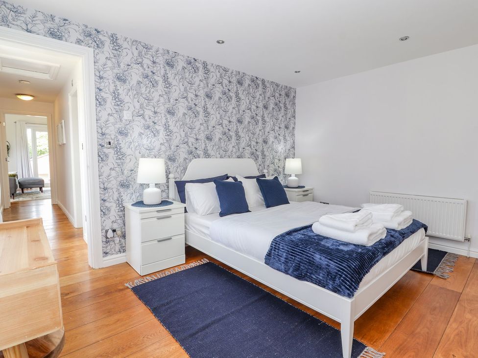 A bedroom with a bed and nightstand at Mount House in Bryniau near Dyserth