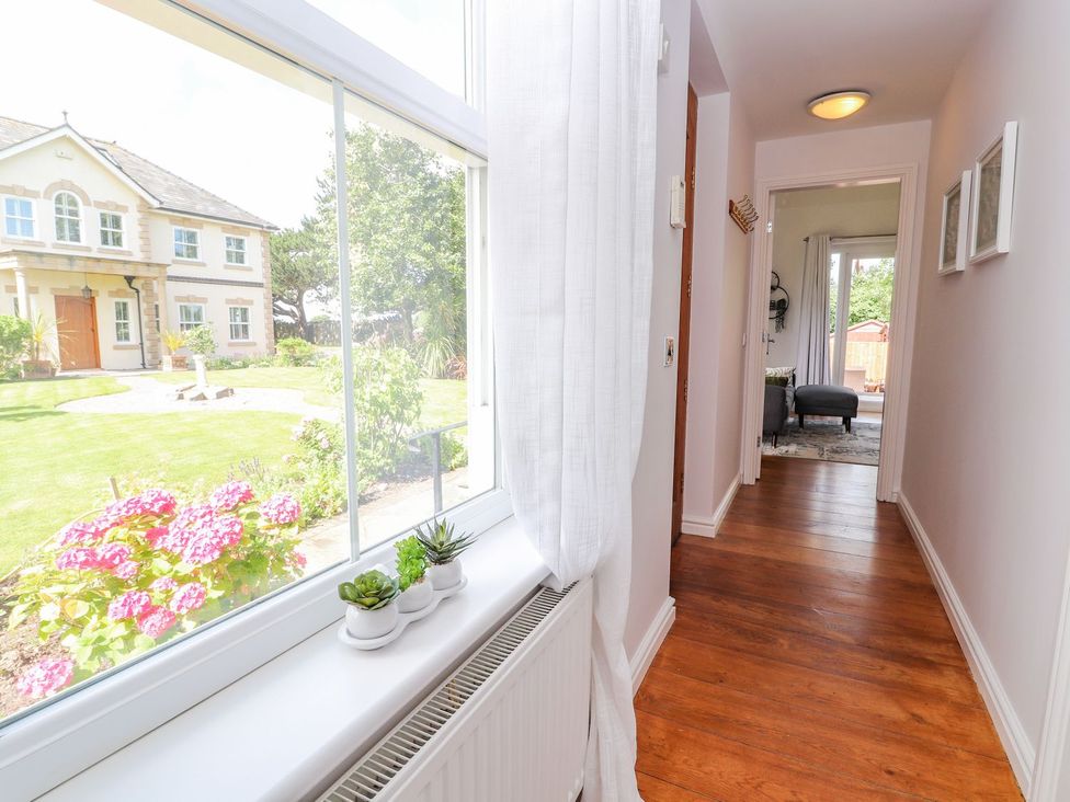 A hallway with a window and plants at Mount House Bryniau near Dyserth