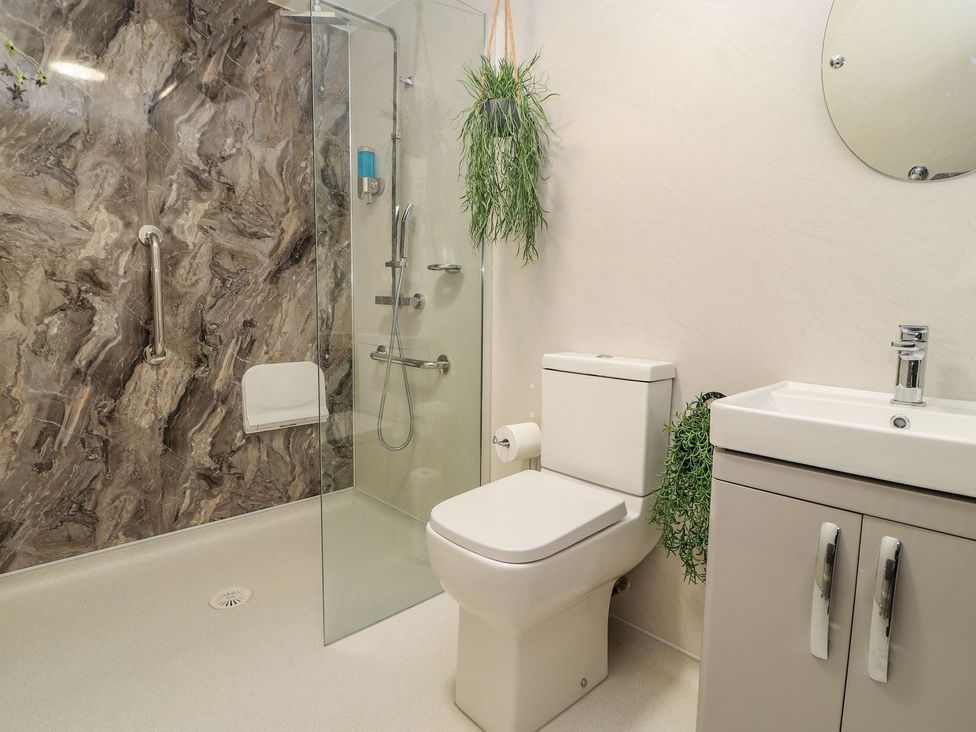 A bathroom with a sink, shower, and toilet at Mount House Bryniau near Dyserth