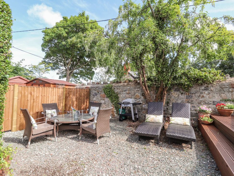 A garden with seating and a barbecue at Mount House, Bryniau near Dyserth