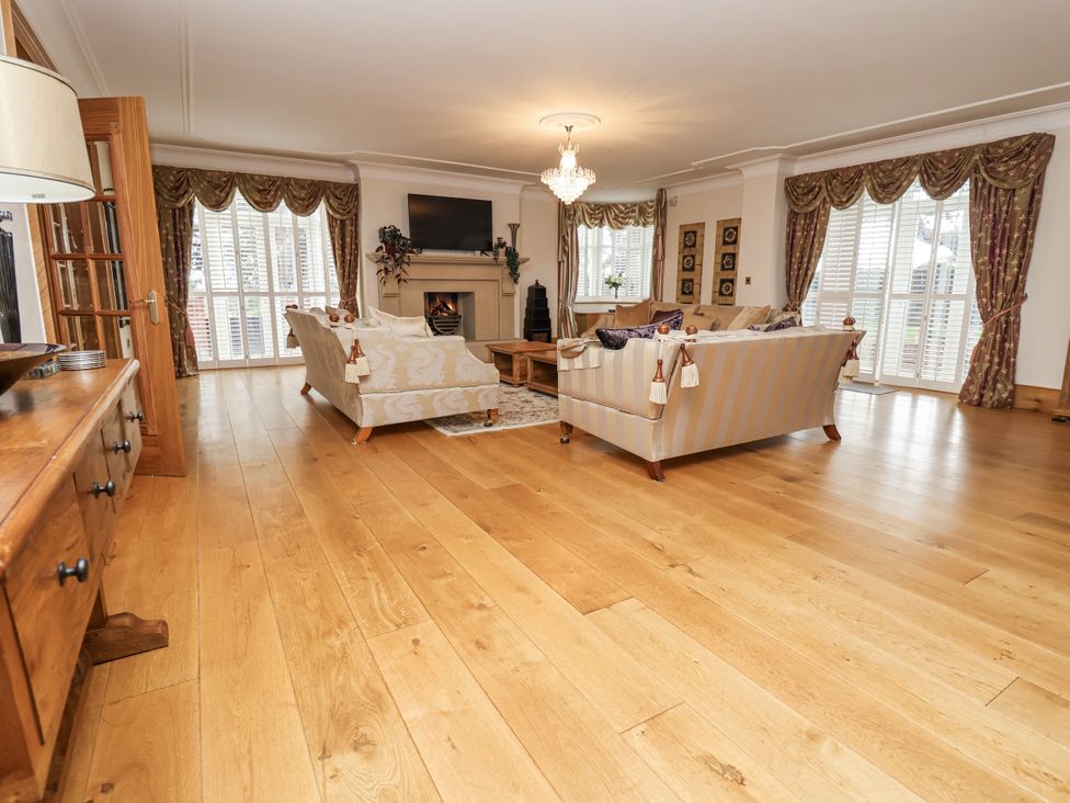 A living room with sofas and a fireplace at Mount House Bryniau near Dyserth