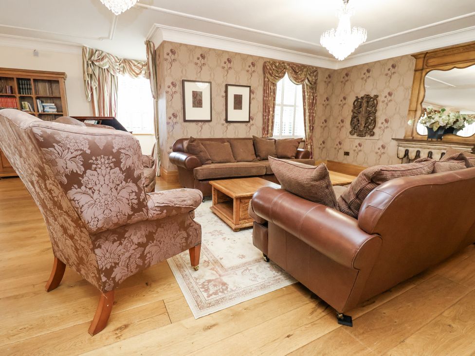 A living room with a sofa and coffee table at Mount House Bryniau near Dyserth