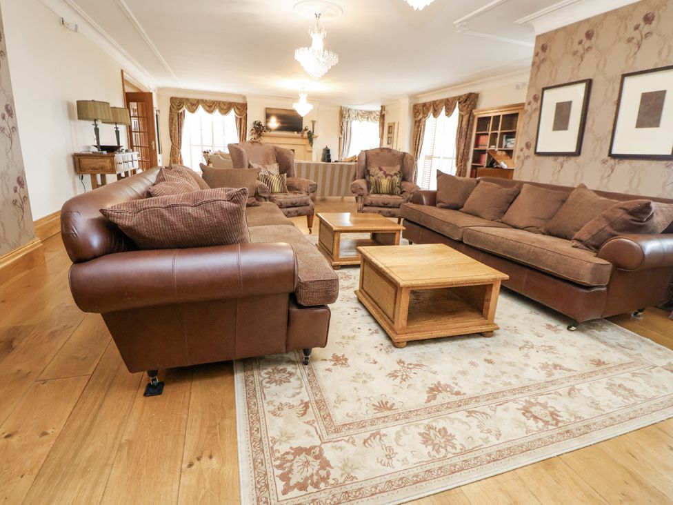 A living room with sofas and a coffee table at Mount House in Bryniau near Dyserth