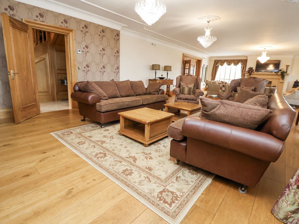 A living room with sofas and a coffee table at Mount House Bryniau near Dyserth
