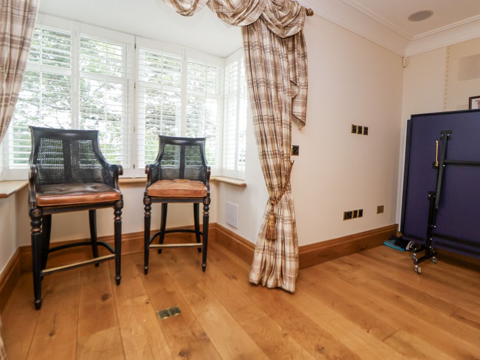 A snug with bar stools and window at Mount House Bryniau near Dyserth