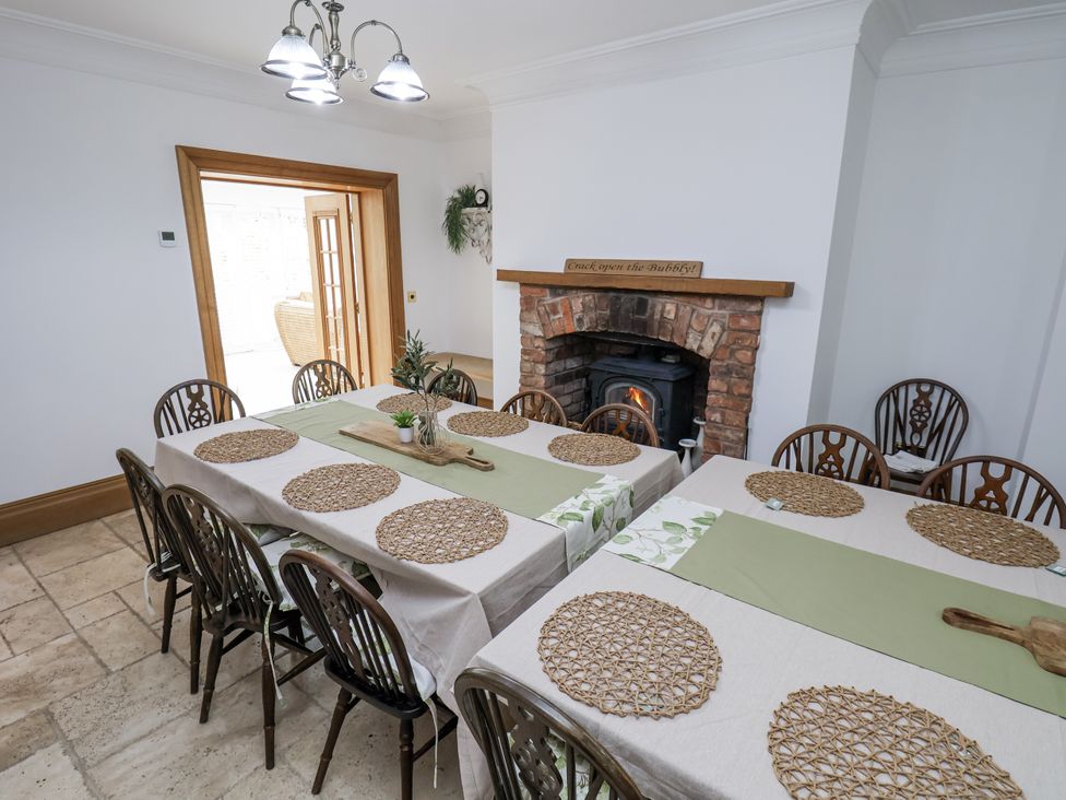 A dining room with tables arranged at Mount House Bryniau near Dyserth