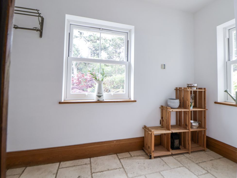 A room with a window and a wooden shelf at Mount House Bryniau near Dyserth