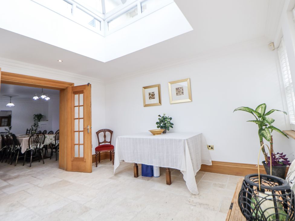 A dining room with a table and chairs at Mount House in Bryniau near Dyserth