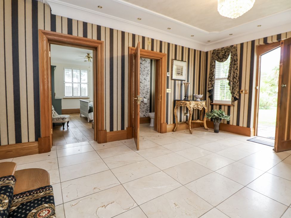 A hallway with doors leading to other rooms at Mount House in Bryniau near Dyserth