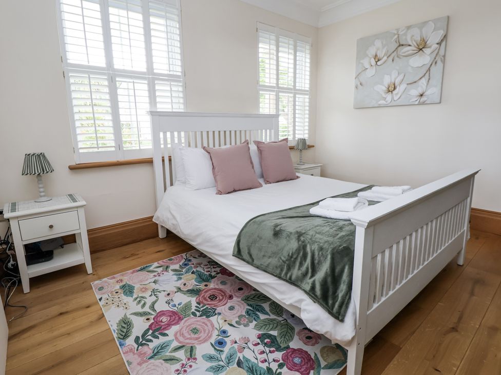 A bedroom with a bed and side tables at Mount House in Bryniau near Dyserth