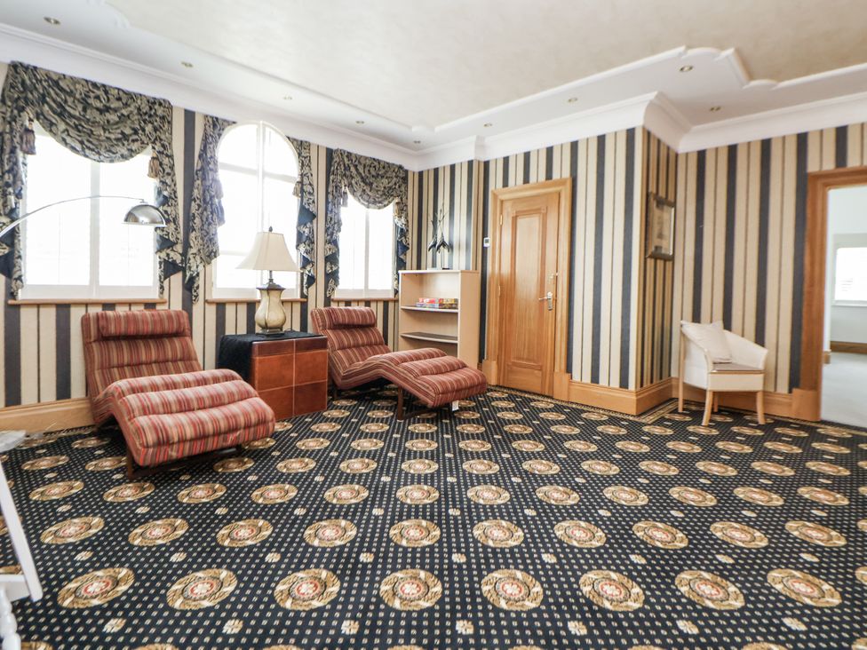 A sitting room with recliner chairs and a lamp at Mount House Bryniau near Dyserth