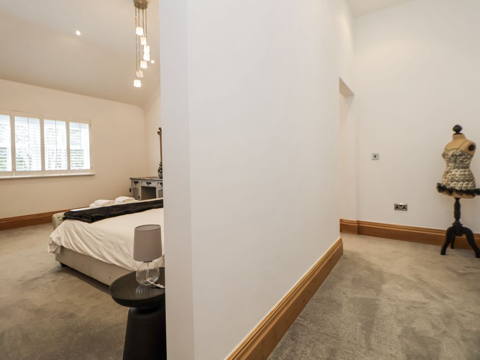 A bedroom with a bed and a mannequin at Mount House in Bryniau near Dyserth