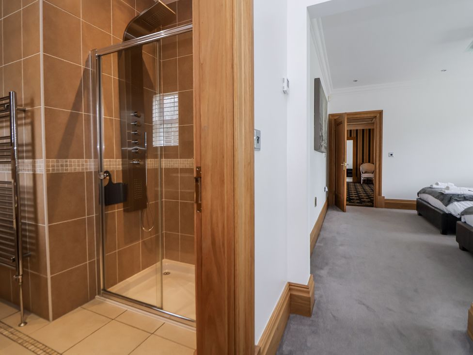 A bathroom with a shower and towel radiator at Mount House in Bryniau near Dyserth