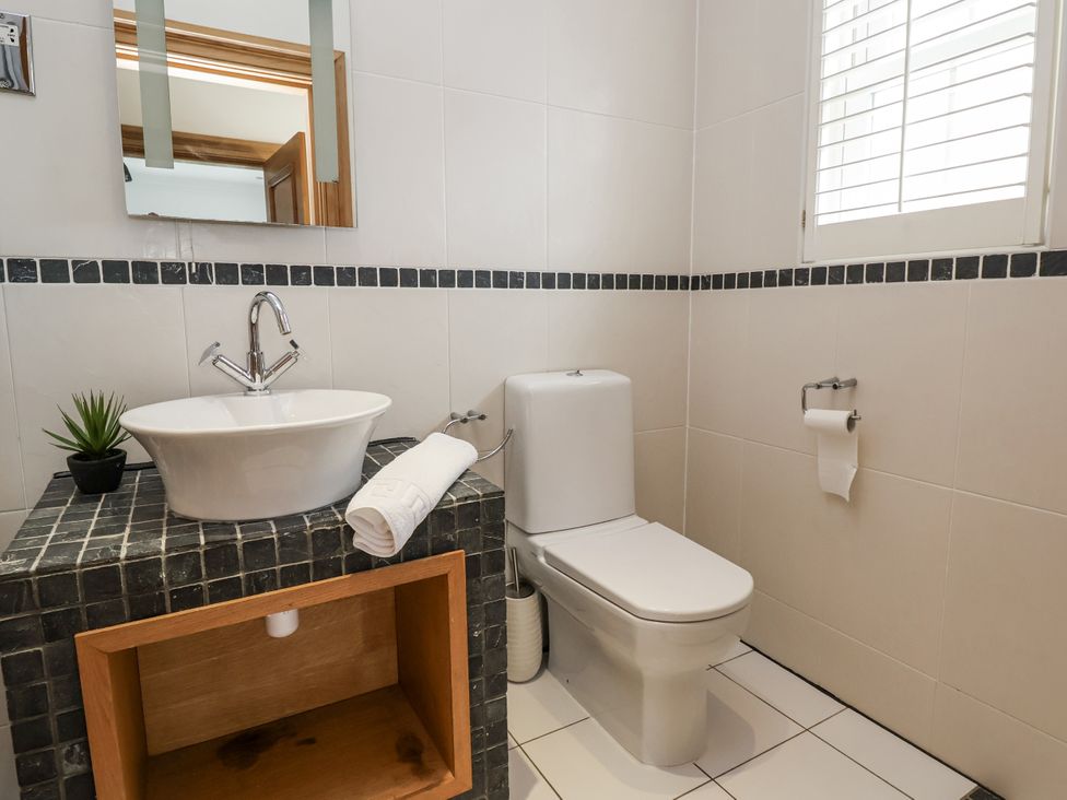 A bathroom with a sink and toilet at Mount House Bryniau near Dyserth
