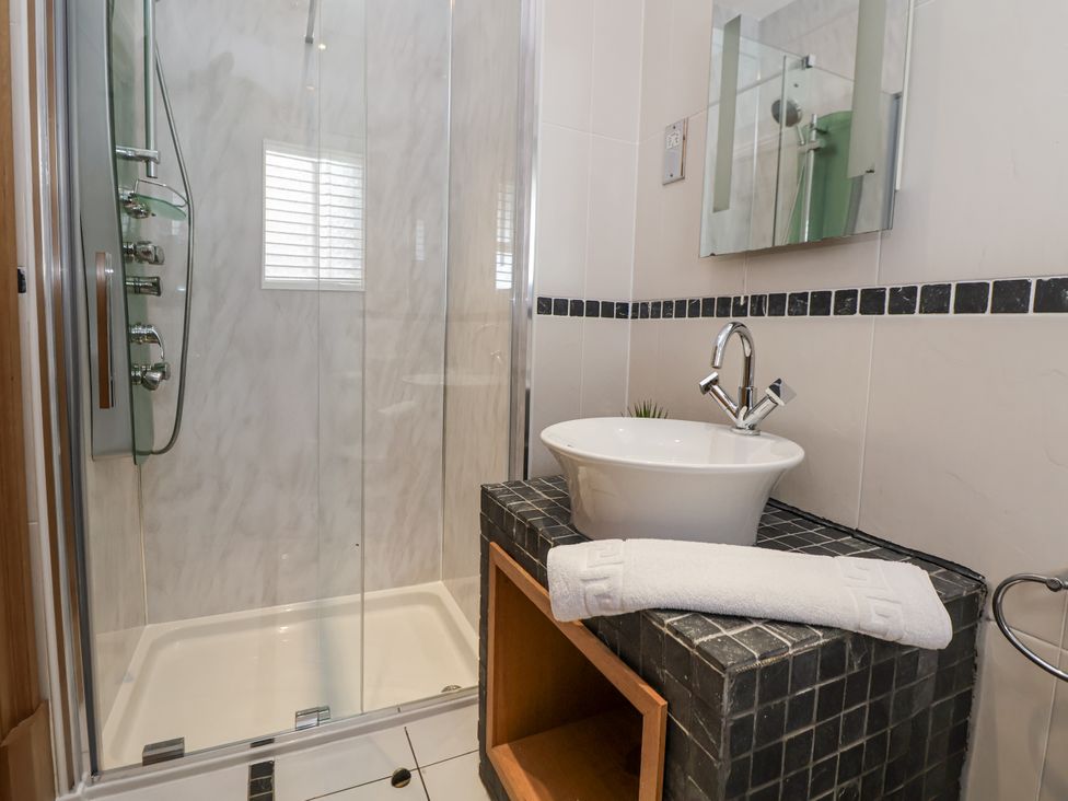 A bathroom with a shower and a sink at Mount House Bryniau near Dyserth