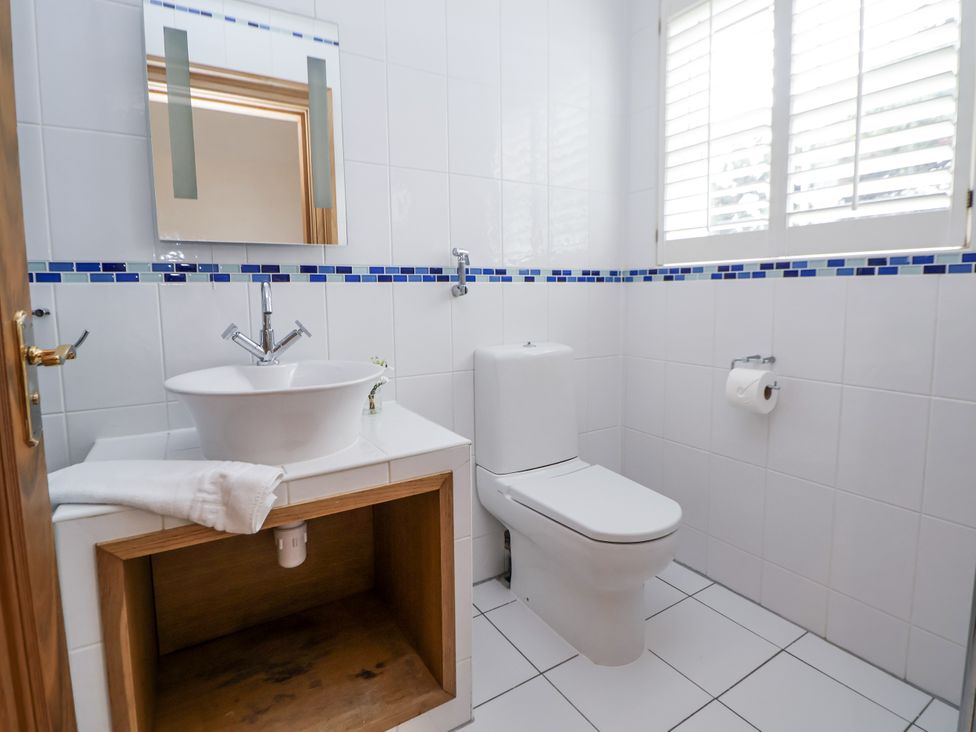 A bathroom with a sink and toilet at Mount House in Bryniau near Dyserth