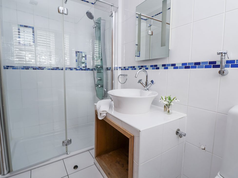 A bathroom with a shower and wash basin at Mount House Bryniau near Dyserth