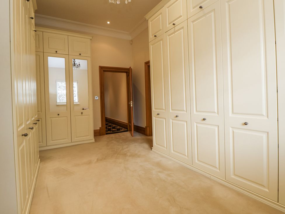 A dressing room with built-in wardrobes at Mount House Bryniau near Dyserth