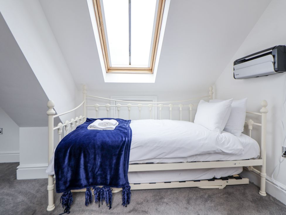 A bedroom with a bed and skylight at Mount House in Bryniau near Dyserth