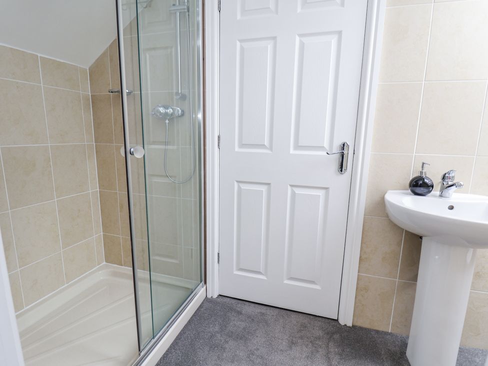 A bathroom with a shower and sink at Mount House Bryniau near Dyserth