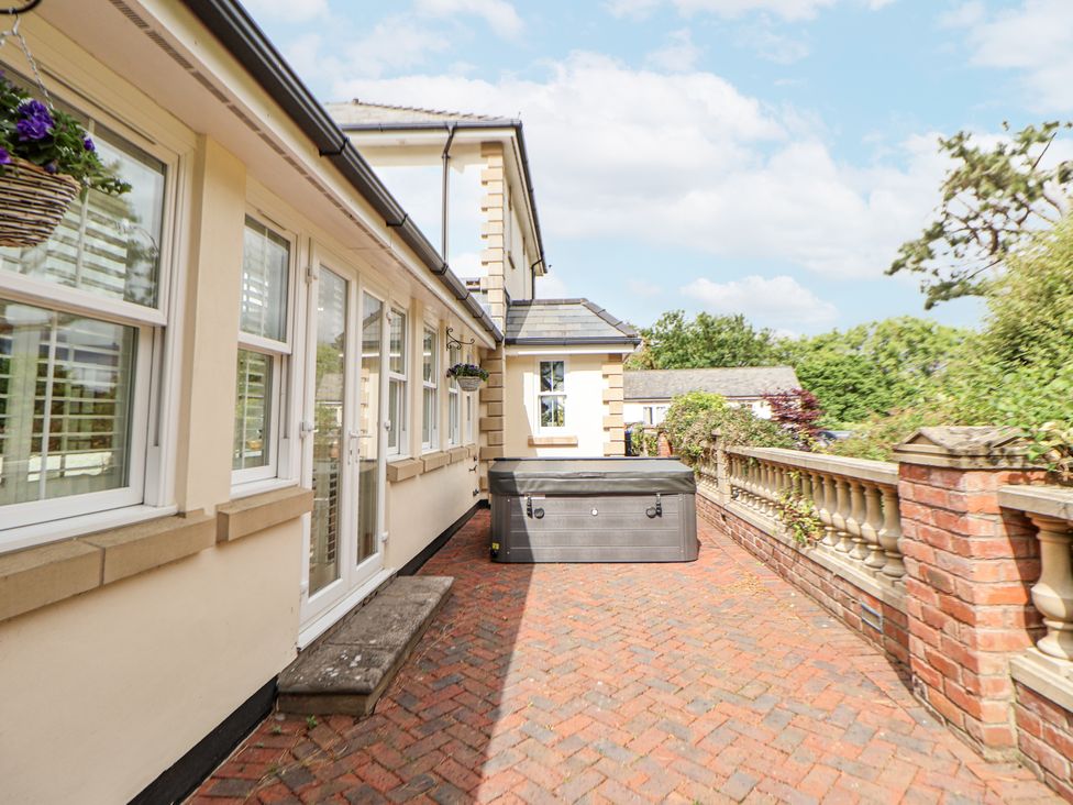 An outdoor area with a hot tub and pathway at Mount House Bryniau near Dyserth