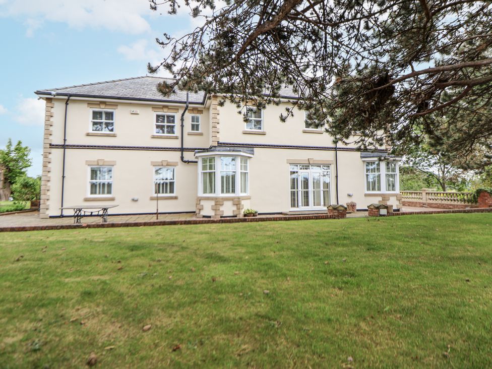 A house with windows and a patio at Mount House Bryniau near Dyserth