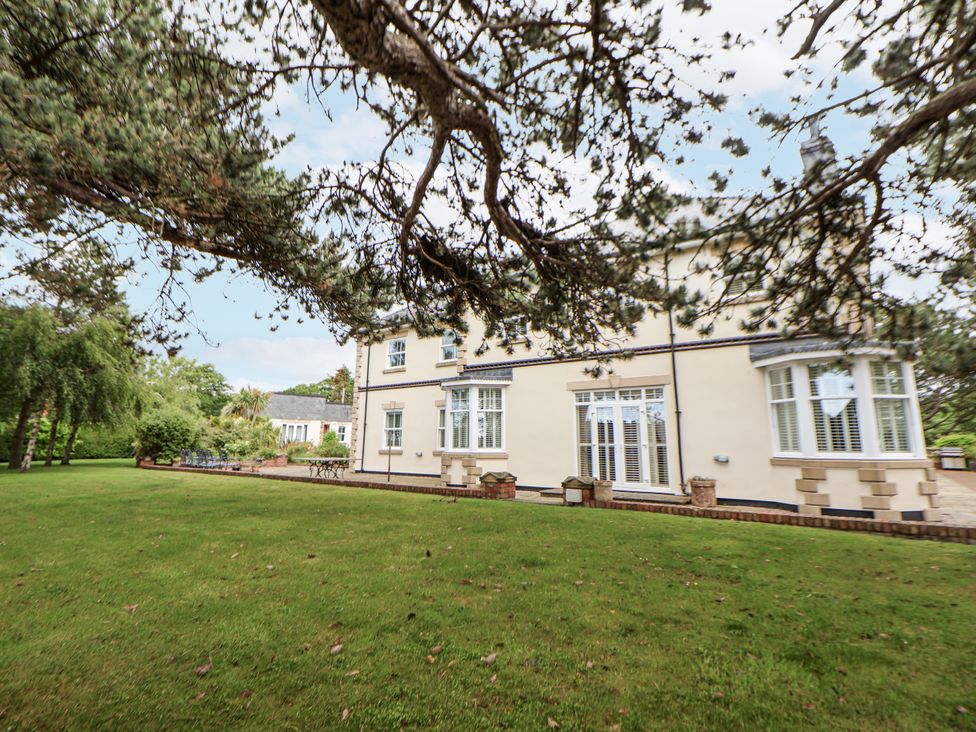 A house with windows and a garden at Mount House in Bryniau near Dyserth