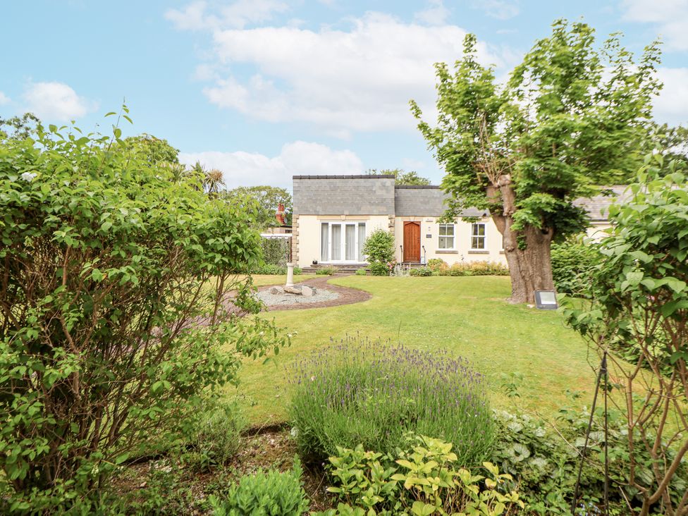 A house with a garden and trees at Mount House Bryniau near Dyserth