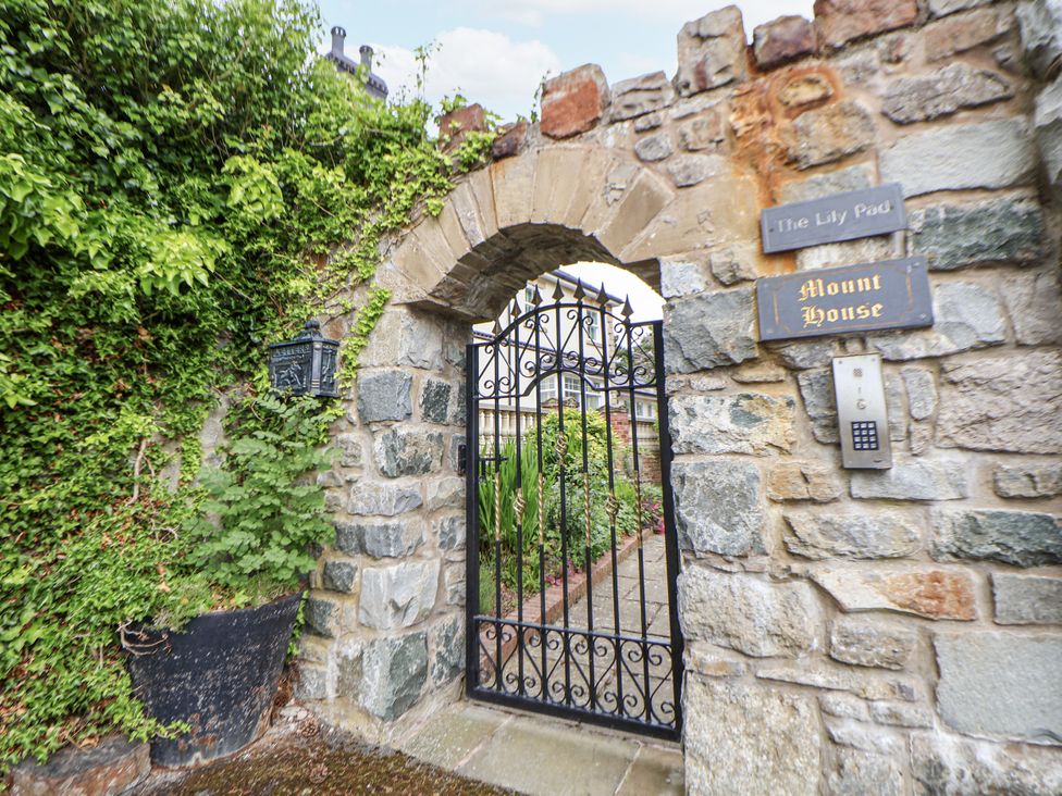 An entrance gate with stone wall and sign at Mount House near Bryniau Dyserth