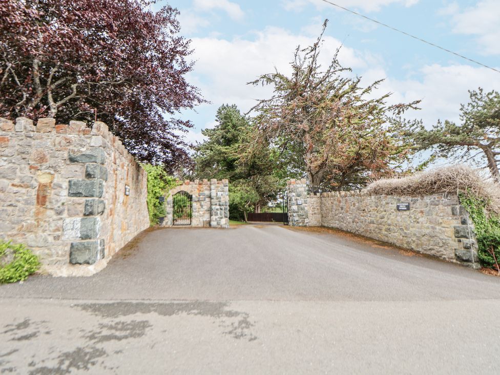 An entrance with a stone wall and gate at Mount House Bryniau near Dyserth