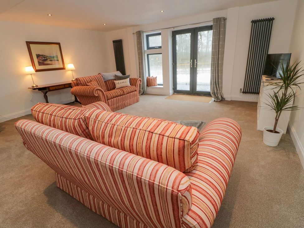 A living room with a sofa and armchair at Harvest Cottage 1 in Berwick-upon-Tweed