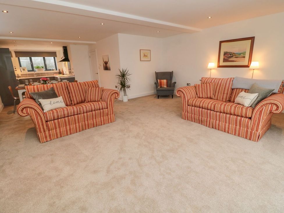 A living room with sofas and an armchair at Harvest Cottage 1 in Berwick-upon-Tweed
