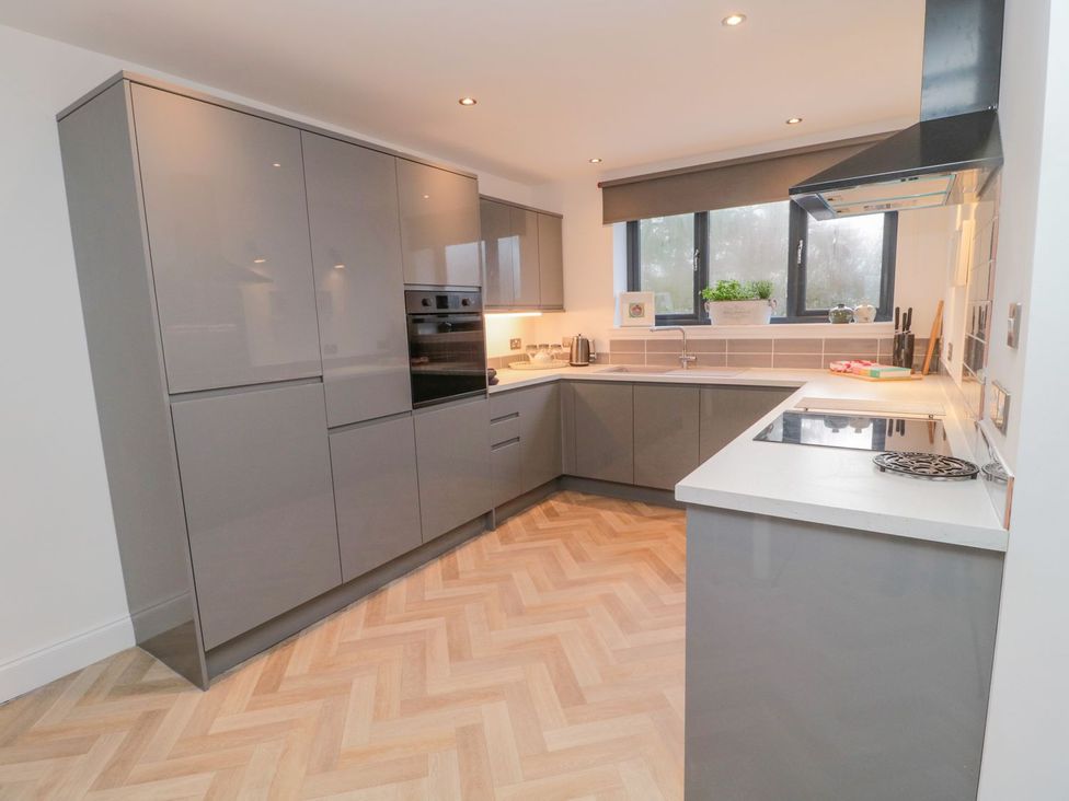 A kitchen with cabinets and a sink at Harvest Cottage 1 in Berwick-upon-Tweed