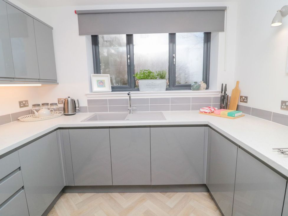 A kitchen with cabinets and a sink at Harvest Cottage 1 in Berwick-upon-Tweed