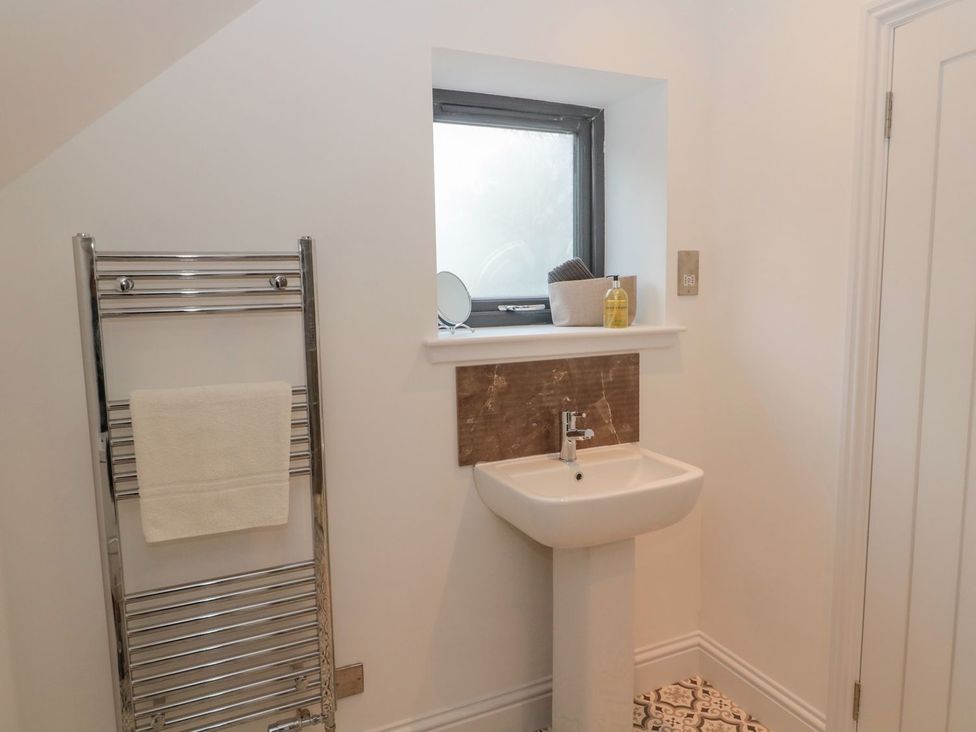 A bathroom with a sink and towel rail at Harvest Cottage 1 in Berwick-upon-Tweed