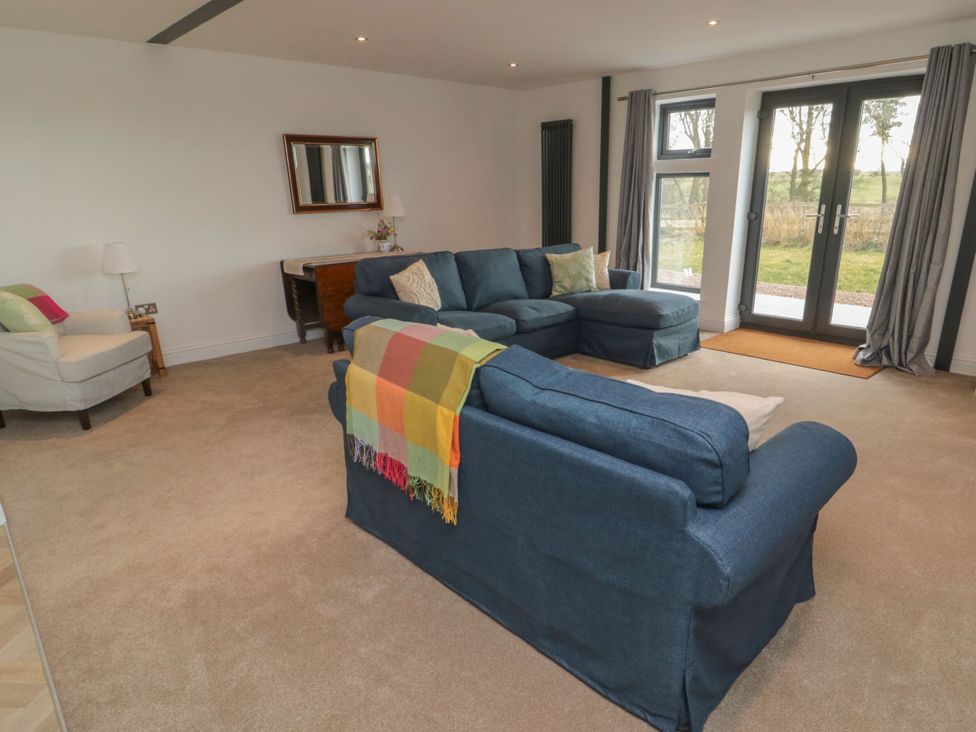 A living room with sofa and armchair at Harvest Cottage 2 in Berwick-upon-Tweed