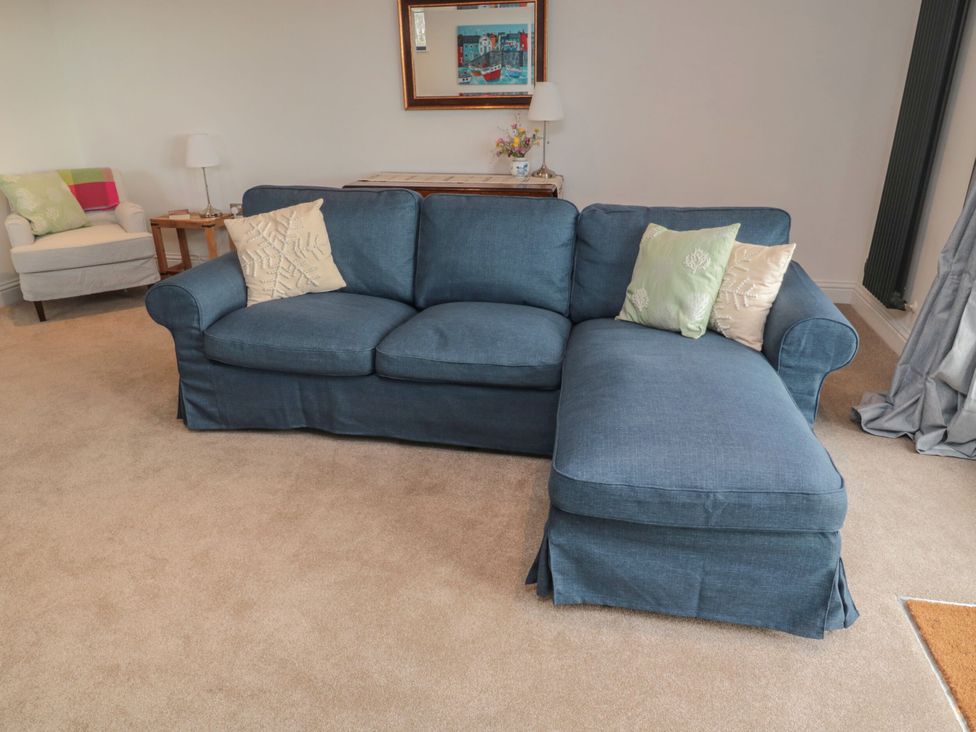 A living room with a blue sofa and armchair at Harvest Cottage 2 Berwick-upon-Tweed