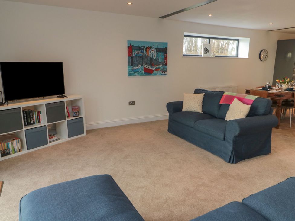 A living room with a sofa and television at Harvest Cottage 2 Berwick-upon-Tweed