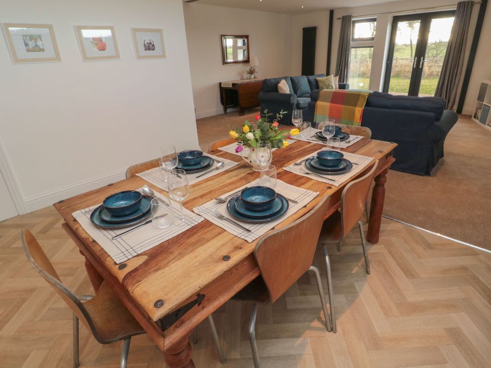 A dining room with a wooden table and chairs at Harvest Cottage 2 Berwick-upon-Tweed