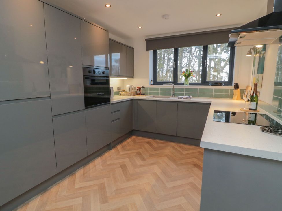 A kitchen with cabinets, oven, and sink at Harvest Cottage 2 Berwick-upon-Tweed