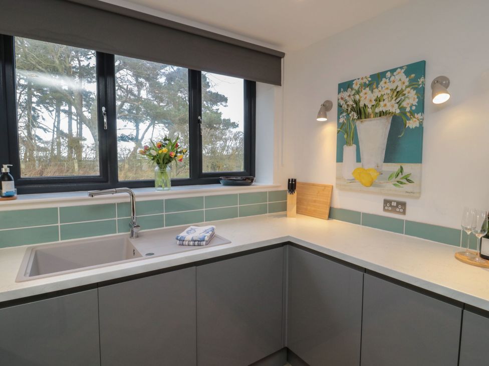A kitchen with a sink and windows at Harvest Cottage 2 in Berwick-upon-Tweed