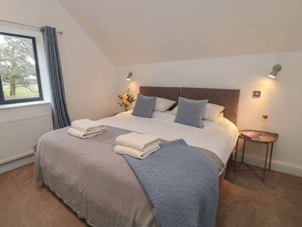 A bedroom with a bed and window at Harvest Cottage 2 Berwick-upon-Tweed