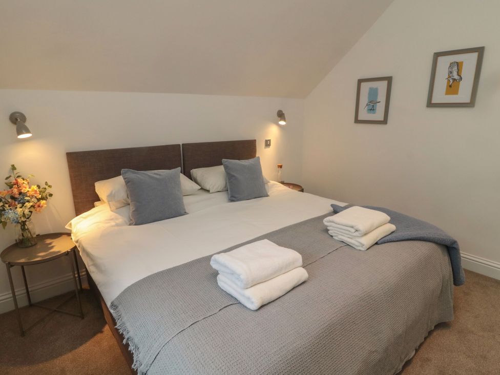 A bedroom with a bed and a bedside table at Harvest Cottage 2 Berwick-upon-Tweed