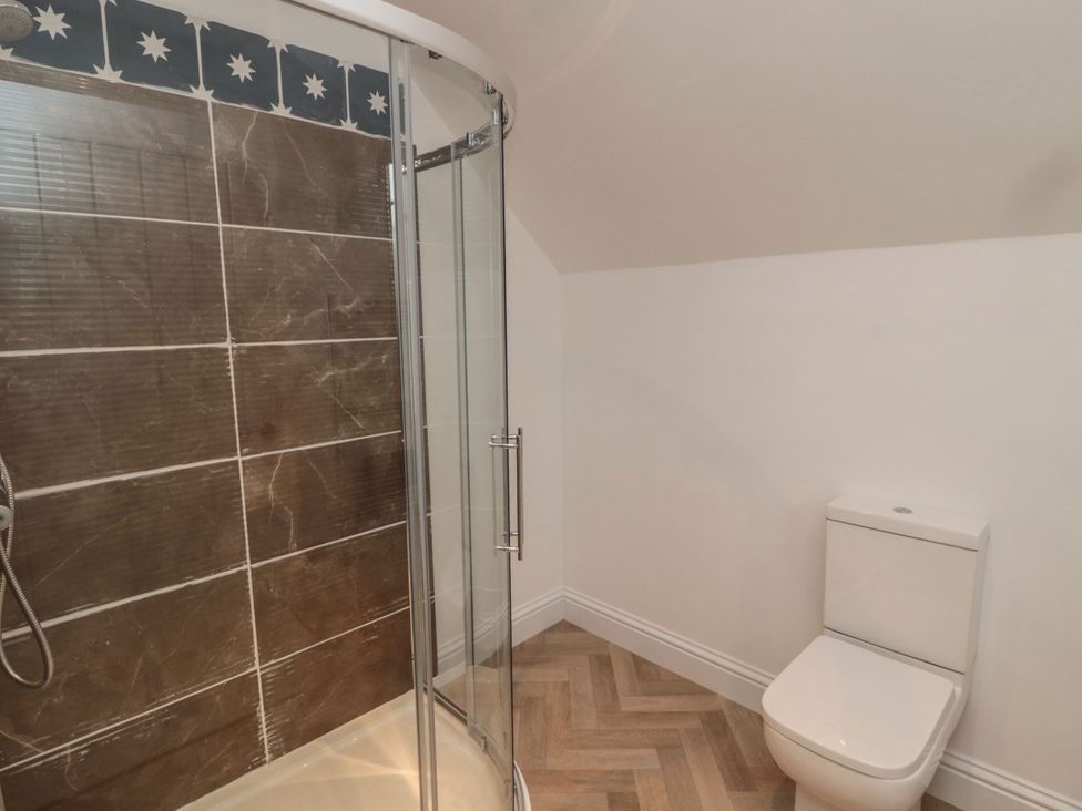 A bathroom with a shower and a toilet at Harvest Cottage 2 in Berwick-upon-Tweed