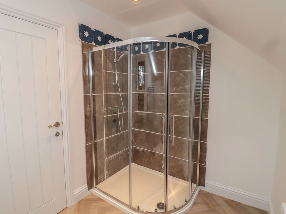 A shower enclosure with tiled walls at Harvest Cottage 2 in Berwick-upon-Tweed
