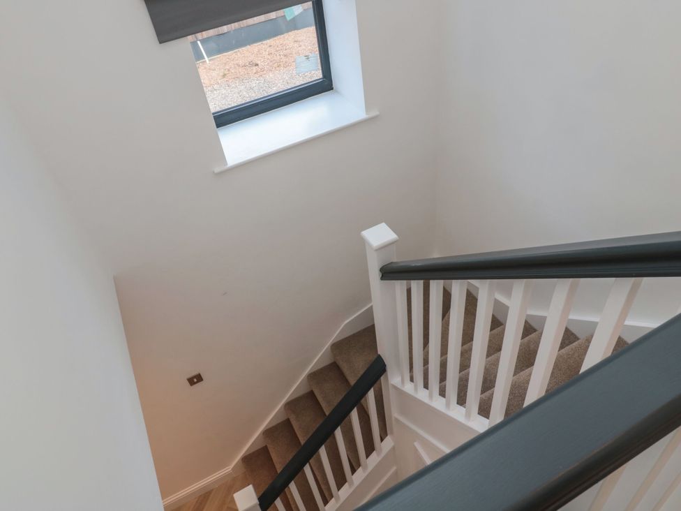 A staircase with handrail and window at Harvest Cottage 2 Berwick-upon-Tweed